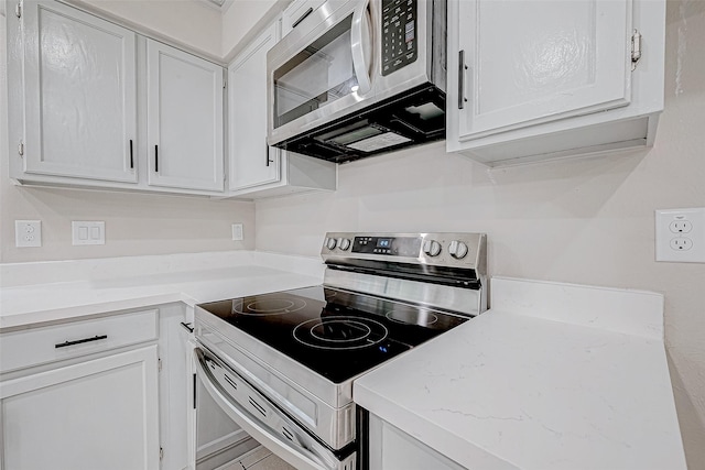 kitchen with white cabinetry and stainless steel appliances