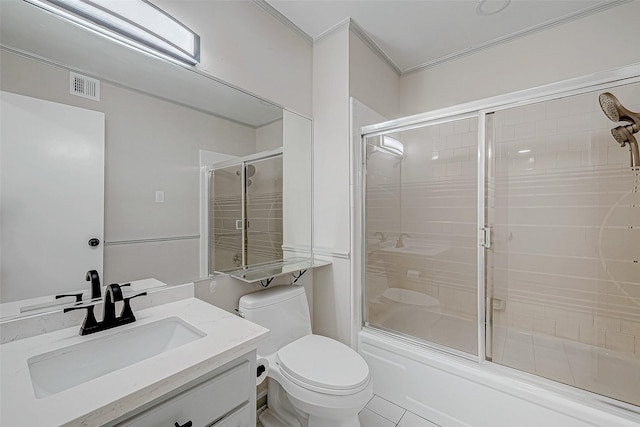 full bathroom featuring combined bath / shower with glass door, tile patterned floors, ornamental molding, vanity, and toilet