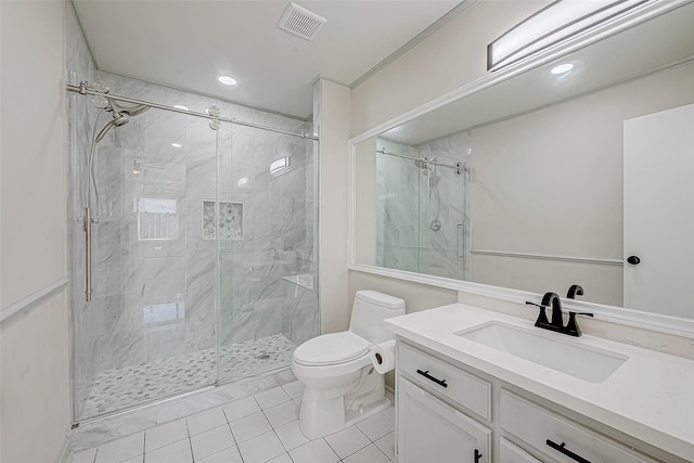 bathroom with tile patterned flooring, vanity, toilet, and walk in shower