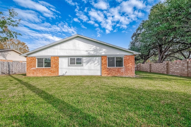 rear view of house with a yard