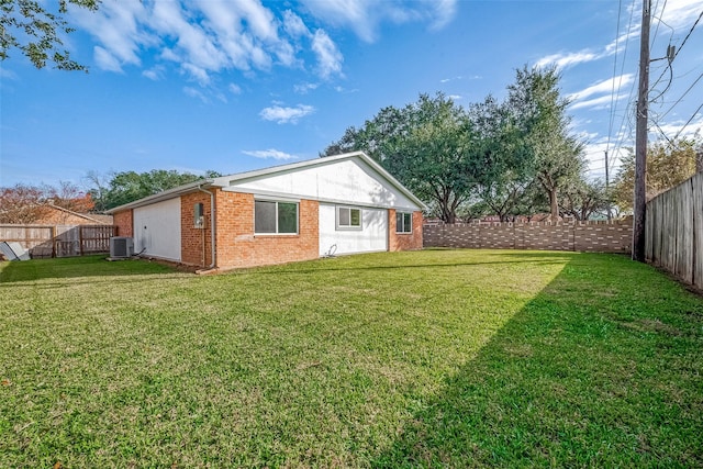 back of house with a yard and central AC unit