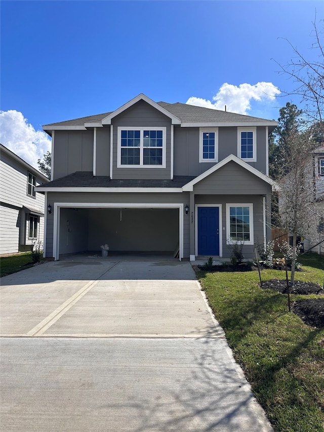 view of front facade featuring a front yard and a garage