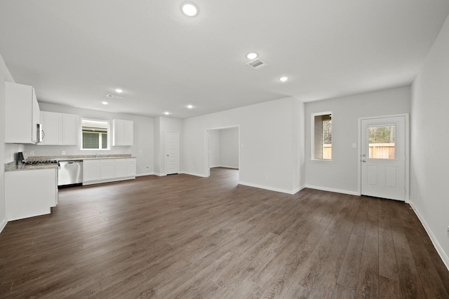 unfurnished living room featuring recessed lighting, visible vents, dark wood finished floors, and baseboards