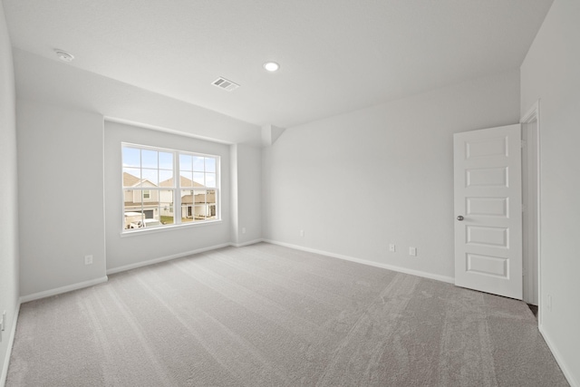 spare room featuring light carpet, baseboards, visible vents, and recessed lighting