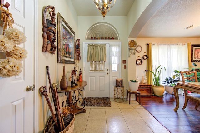 entrance foyer featuring a textured ceiling and light wood-type flooring