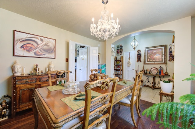 dining room featuring a chandelier, hardwood / wood-style floors, and a textured ceiling