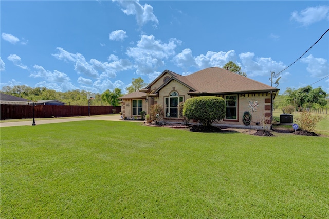 rear view of property with a lawn and central AC