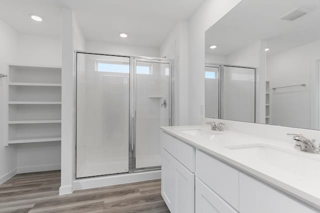 bathroom with vanity, wood-type flooring, and an enclosed shower