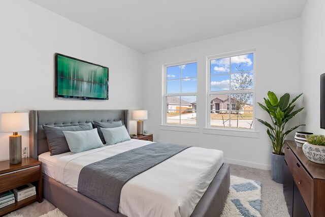 bedroom featuring light carpet