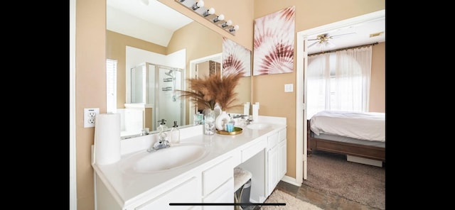 bathroom featuring ceiling fan, a shower with door, vanity, and lofted ceiling