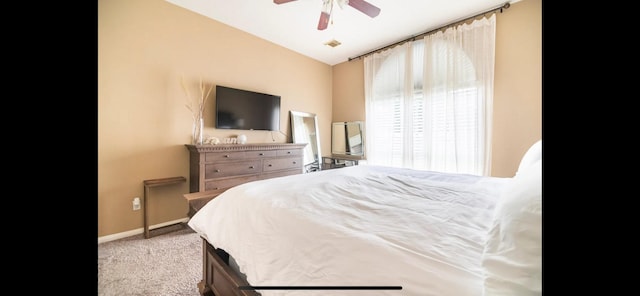 bedroom with ceiling fan, lofted ceiling, and light carpet