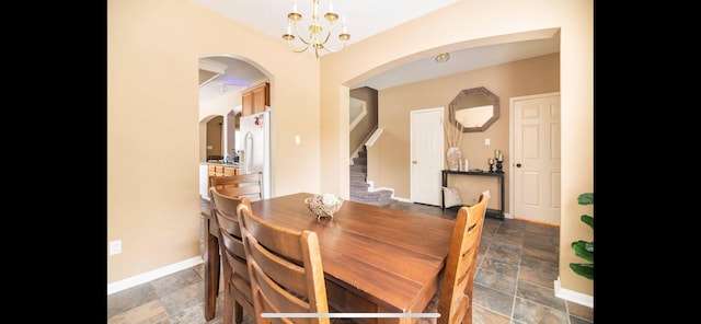 dining area featuring a notable chandelier