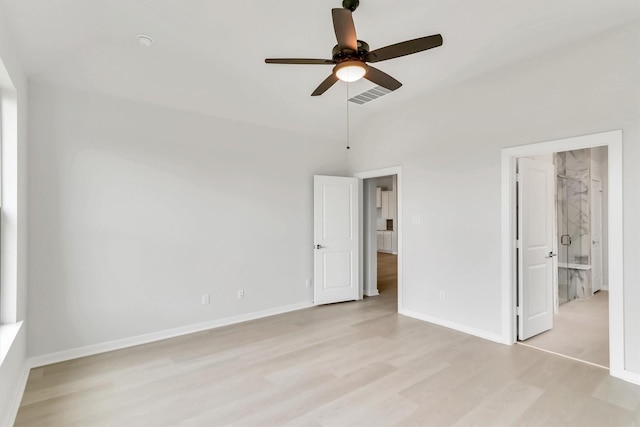 unfurnished bedroom with ensuite bath, ceiling fan, and light hardwood / wood-style floors