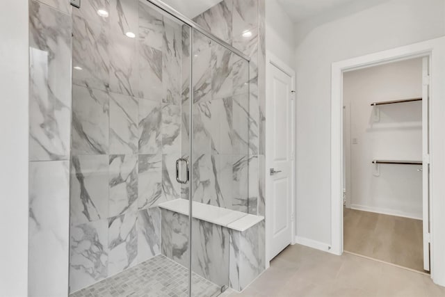 bathroom with tile patterned flooring and walk in shower