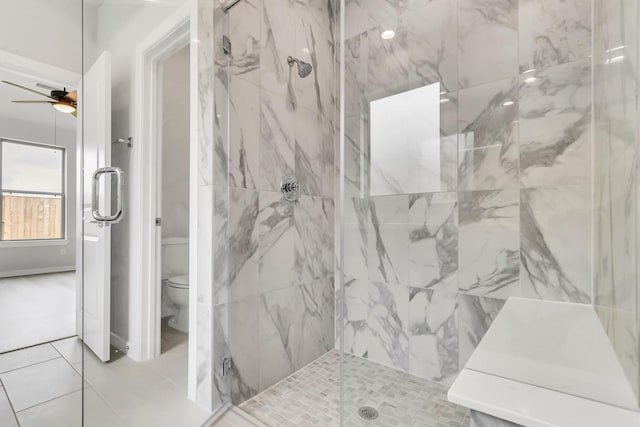 bathroom featuring tile patterned flooring, toilet, walk in shower, and ceiling fan