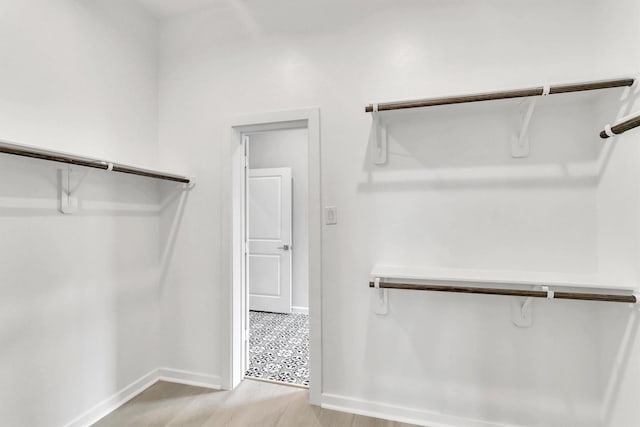 walk in closet featuring light hardwood / wood-style floors