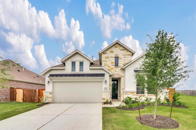 view of front of home featuring a front yard and a garage