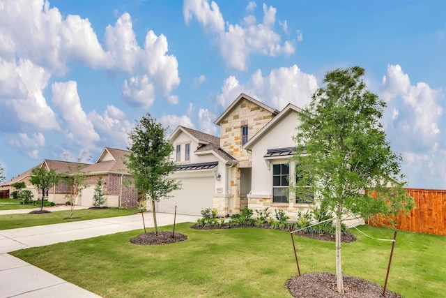 view of front of property with a front yard and a garage