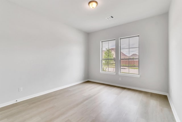 unfurnished room with light hardwood / wood-style floors