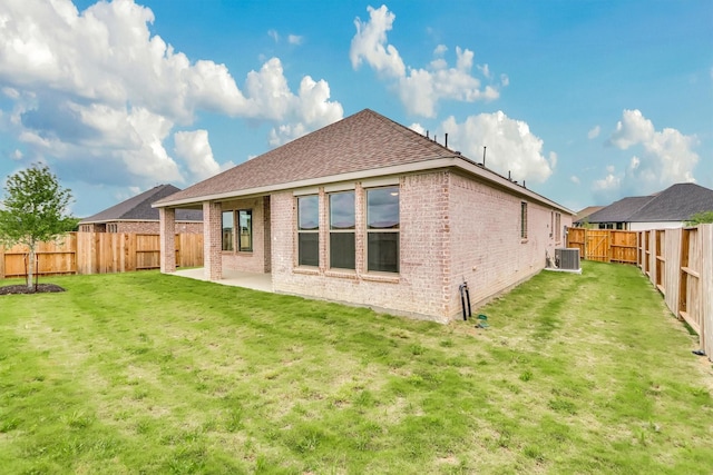 back of house featuring a yard, cooling unit, and a patio