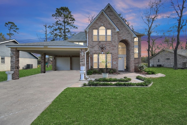 view of front facade with a yard, a garage, and a carport