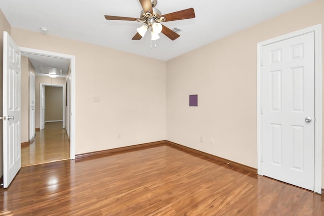 spare room featuring ceiling fan and hardwood / wood-style flooring