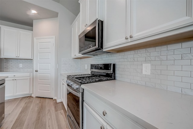 kitchen featuring white cabinetry, light wood-type flooring, and appliances with stainless steel finishes