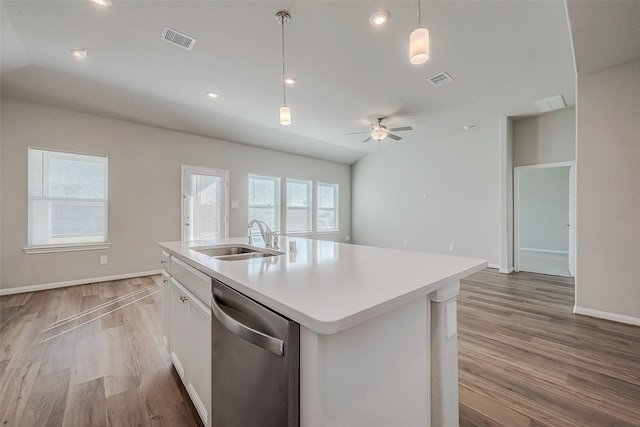 kitchen with sink, stainless steel dishwasher, pendant lighting, a center island with sink, and white cabinets