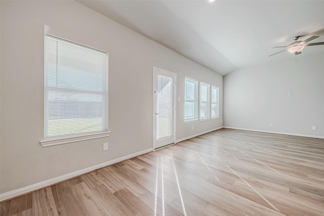 spare room featuring ceiling fan, plenty of natural light, lofted ceiling, and light hardwood / wood-style flooring