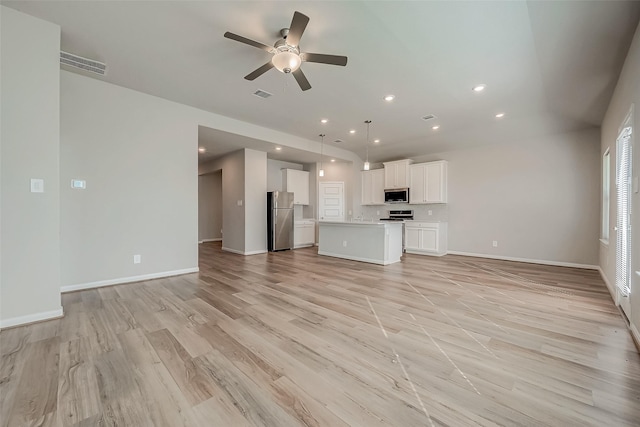 unfurnished living room featuring light hardwood / wood-style floors and ceiling fan