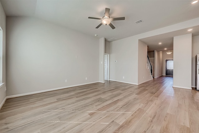 empty room featuring ceiling fan and light hardwood / wood-style flooring