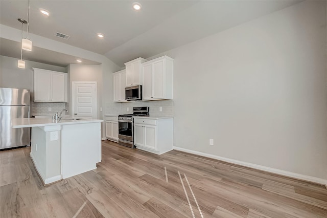 kitchen featuring white cabinets, light hardwood / wood-style floors, and appliances with stainless steel finishes