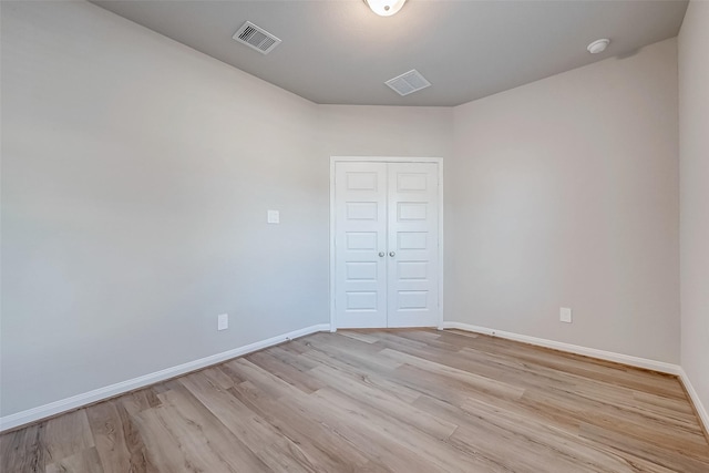 spare room with light hardwood / wood-style flooring