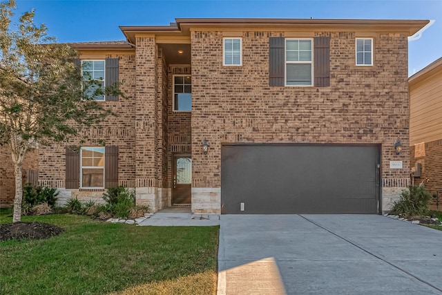 view of front of home with a front yard and a garage