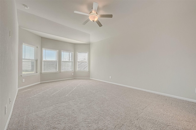 carpeted spare room with ceiling fan