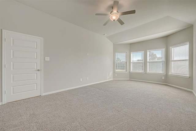 carpeted empty room with ceiling fan and vaulted ceiling