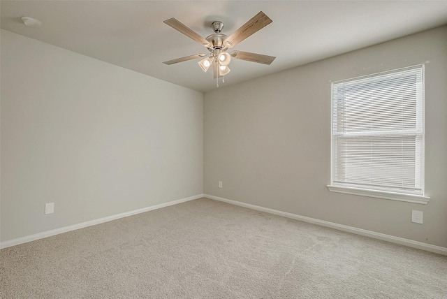 spare room featuring carpet floors, plenty of natural light, and ceiling fan