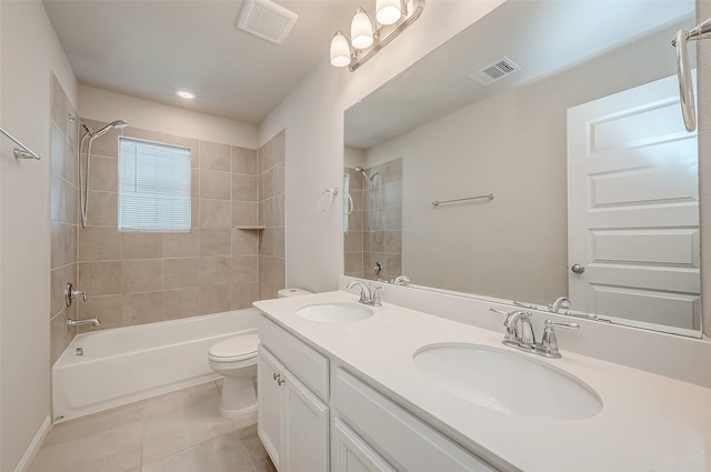 full bathroom featuring tile patterned floors, toilet, vanity, and tiled shower / bath