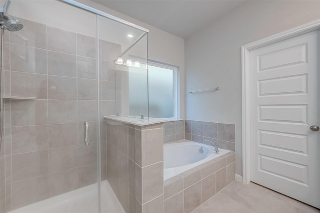 bathroom with tile patterned floors and separate shower and tub