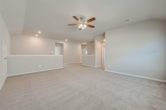 carpeted empty room with vaulted ceiling and ceiling fan