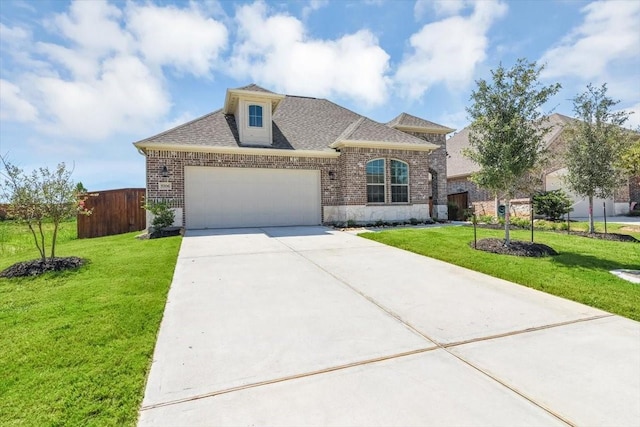 view of front facade with a garage and a front lawn