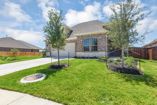 view of front of house featuring a garage and a front yard