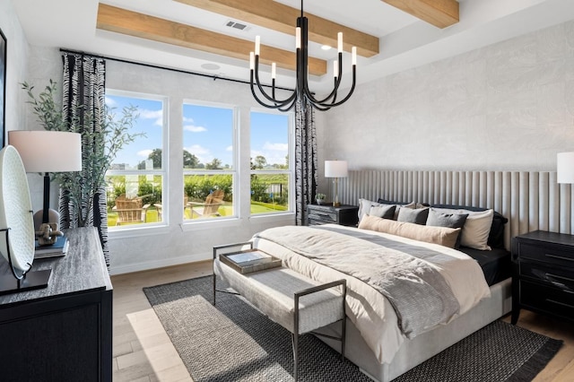 bedroom with beam ceiling, light hardwood / wood-style floors, and an inviting chandelier