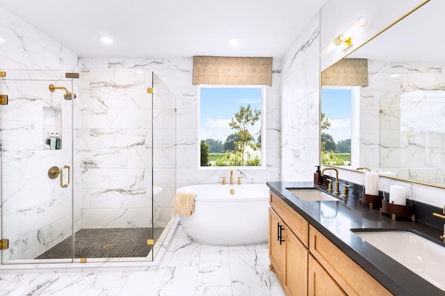 bathroom with plus walk in shower, vanity, a wealth of natural light, and tile walls