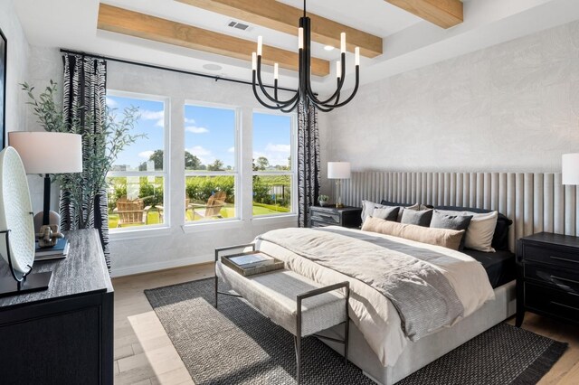 bedroom with beam ceiling, visible vents, light wood-style floors, a chandelier, and baseboards