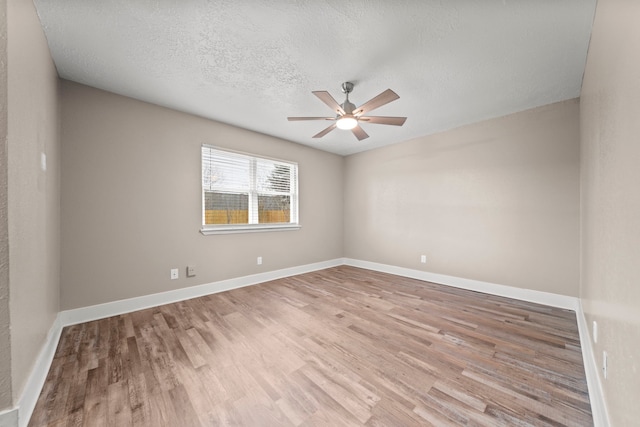 unfurnished room with light wood-type flooring, ceiling fan, and a textured ceiling