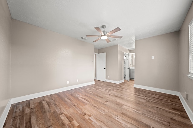 spare room with light wood-type flooring and ceiling fan