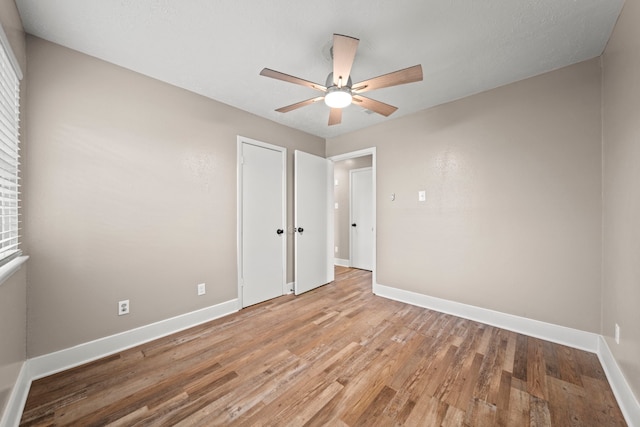 unfurnished bedroom featuring ceiling fan and light wood-type flooring