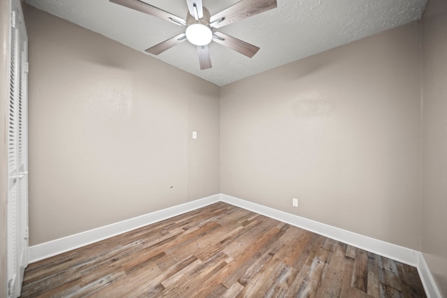 spare room featuring hardwood / wood-style flooring, ceiling fan, and a textured ceiling