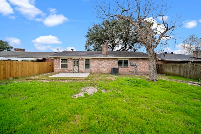 back of property featuring central air condition unit, a patio, and a lawn